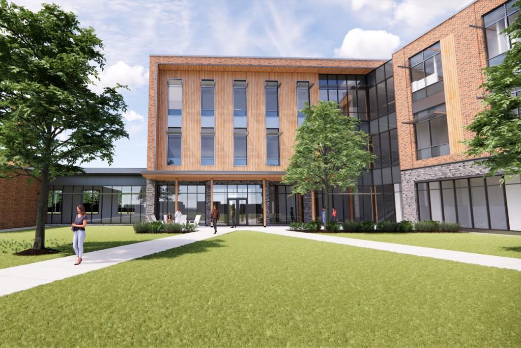 A rendering of the exterior of the upcoming C O M building showing a brick building and grass quad